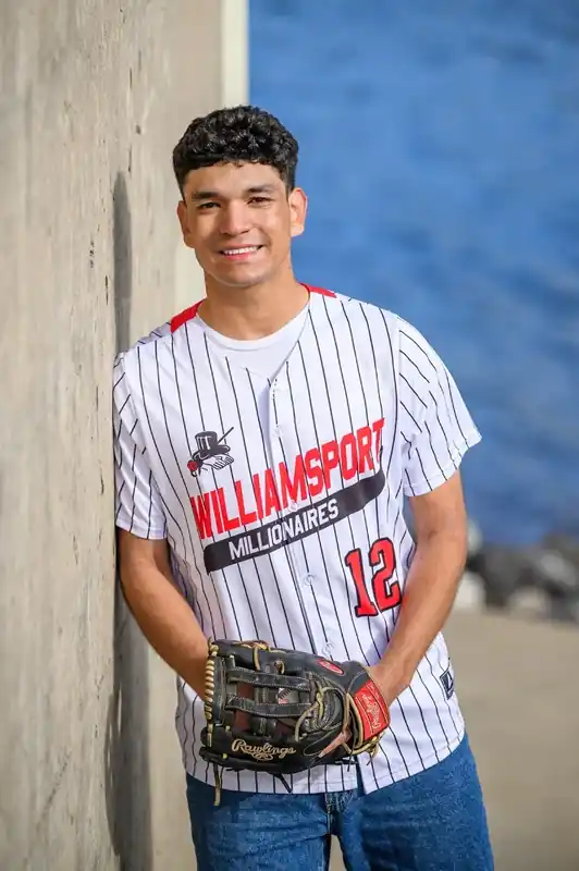 2026 Carl E. Stotz Little League Baseball Scholarship: 14 Winners 14 Giovanni White wearing a baseball jersey and holding a glove during a high school sports portrait session